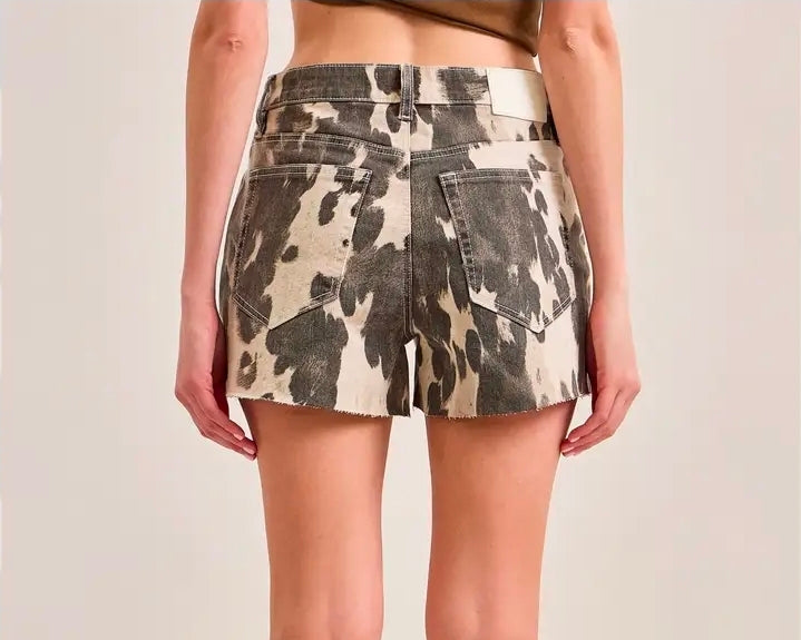COW PRINTED JAGGED HEM SHORTS by HIDDEN JEANS