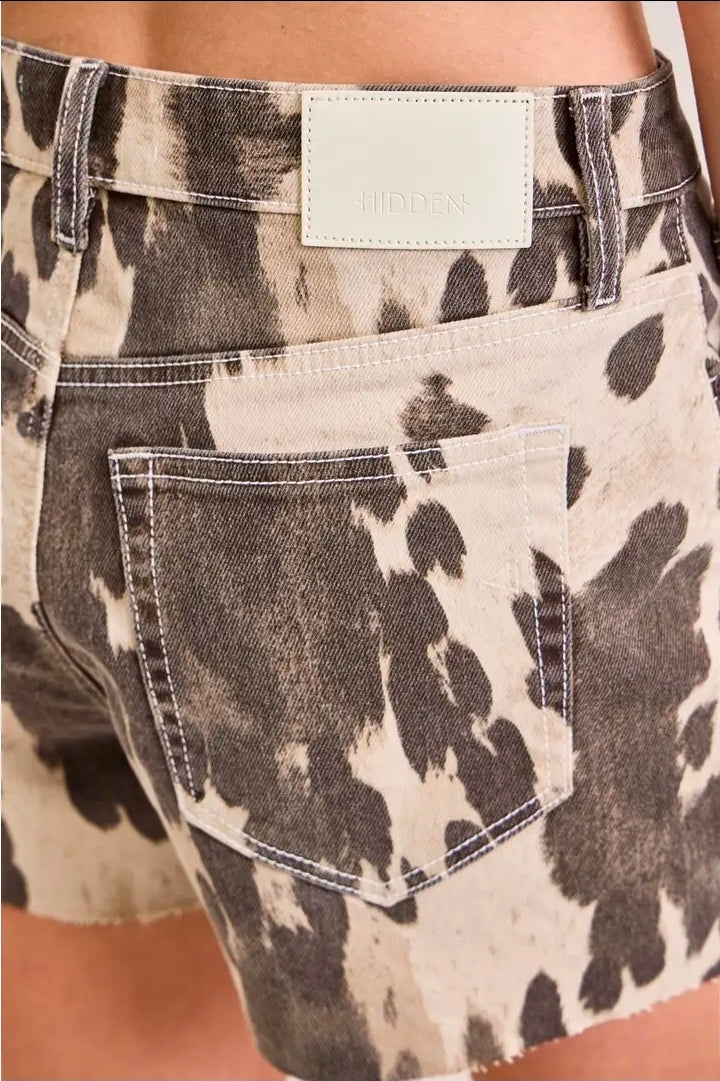 COW PRINTED JAGGED HEM SHORTS by HIDDEN JEANS